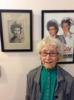 Photo of Lois Ross in front of two USCNC photos